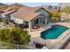 Home aerial view with a backyard oasis, covered patio, built in grill, and a sparkling pool at 4665 S Palacio Way, Gold Canyon, AZ 85118