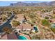 The aerial view shows the home, pool, and landscaping within a desert community with mountain views at 4665 S Palacio Way, Gold Canyon, AZ 85118