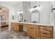 Bathroom featuring double sinks, wood cabinets, and mosaic tile backsplash at 4665 S Palacio Way, Gold Canyon, AZ 85118