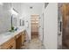 Elegant bathroom with double sinks, wood cabinets and tiled walk-in shower at 4665 S Palacio Way, Gold Canyon, AZ 85118