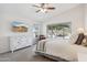 Well-lit bedroom featuring a large window, TV and dresser at 4665 S Palacio Way, Gold Canyon, AZ 85118