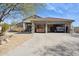 Spacious three car garage featuring a covered carport and ample parking for multiple vehicles at 4665 S Palacio Way, Gold Canyon, AZ 85118