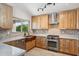 Modern kitchen with stainless steel appliances, custom cabinetry, and a stylish backsplash at 4665 S Palacio Way, Gold Canyon, AZ 85118