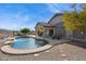 Backyard features pool with waterfall, covered patio, and desert landscaping for relaxation at 4665 S Palacio Way, Gold Canyon, AZ 85118