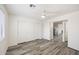 Bright bedroom featuring wood-look flooring, a ceiling fan, and closet space at 4901 S Calle Los Cerros Dr # 264, Tempe, AZ 85282