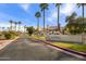 Gated community entrance with landscaping and signage under a blue sky at 4901 S Calle Los Cerros Dr # 264, Tempe, AZ 85282