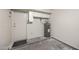 Garage featuring water heater, storage cabinets, and access door at 4901 S Calle Los Cerros Dr # 264, Tempe, AZ 85282