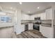 Modern kitchen featuring white cabinets, stainless steel appliances, and gray countertops at 4901 S Calle Los Cerros Dr # 264, Tempe, AZ 85282