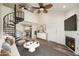 Staged living room with spiral staircase, fireplace, wood-look floors, and view to kitchen at 4901 S Calle Los Cerros Dr # 264, Tempe, AZ 85282