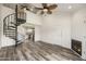 Living room with spiral staircase, fireplace, wood-look floors, and view to kitchen at 4901 S Calle Los Cerros Dr # 264, Tempe, AZ 85282