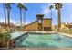 Community pool area with clear blue water, palm trees, and poolside seating at 4901 S Calle Los Cerros Dr # 264, Tempe, AZ 85282