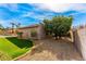 Large backyard with desert landscaping, citrus trees, and green lawn area offering a private retreat at 5024 E Le Marche Ave, Scottsdale, AZ 85254