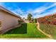 Well-manicured backyard features vibrant landscaping and green lawn providing a serene outdoor space at 5024 E Le Marche Ave, Scottsdale, AZ 85254