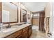 Bathroom featuring double sinks, granite countertops, and a tiled shower-tub combo at 5024 E Le Marche Ave, Scottsdale, AZ 85254