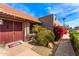 Inviting front entrance with a red door, desert landscaping and a neatly paved walkway at 5024 E Le Marche Ave, Scottsdale, AZ 85254