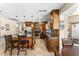 Open concept kitchen featuring stainless steel appliances, custom cabinets, and island with barstool seating at 5024 E Le Marche Ave, Scottsdale, AZ 85254