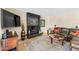 Bright living room features a dark fireplace, leather couch, and plush rug creating an inviting space at 5024 E Le Marche Ave, Scottsdale, AZ 85254