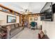 Cozy living room with custom built-in shelving, a ceiling fan, and comfortable seating at 5024 E Le Marche Ave, Scottsdale, AZ 85254