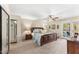 Spacious main bedroom with a king bed, ceiling fan, private ensuite, and a glass sliding door at 5024 E Le Marche Ave, Scottsdale, AZ 85254