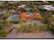 Fantastic aerial view of the private estate showcasing the pool, tennis court, and lush landscaping at 5567 E Mcdonald Dr, Paradise Valley, AZ 85253