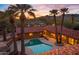 Aerial view of a backyard pool and desert landscape at sunset at 5567 E Mcdonald Dr, Paradise Valley, AZ 85253