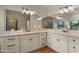 Bathroom featuring dual sinks, tile floors, bright lighting, and an extra large mirror at 5567 E Mcdonald Dr, Paradise Valley, AZ 85253