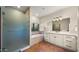 Well-lit bathroom featuring a glass enclosed shower, separate tub, and a large vanity area at 5567 E Mcdonald Dr, Paradise Valley, AZ 85253