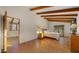 Bedroom with high ceilings, exposed wood beams, terracotta tile floors, and adjacent bonus room at 5567 E Mcdonald Dr, Paradise Valley, AZ 85253