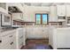 White kitchen with a large window, custom cabinets, and decorative tile accents at 5567 E Mcdonald Dr, Paradise Valley, AZ 85253