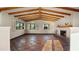 Spacious living room with wood-beamed ceiling and a decorative tiled fireplace at 5567 E Mcdonald Dr, Paradise Valley, AZ 85253