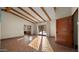 Bright room with beamed ceiling, terra cotta flooring, and glass doors to the outdoor pool area at 5567 E Mcdonald Dr, Paradise Valley, AZ 85253