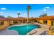 Backyard pool with mature palm trees surrounded by the desert landscape at 5567 E Mcdonald Dr, Paradise Valley, AZ 85253