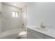 This bathroom features new marble tile and gold fixtures at 5731 W Morten Ave, Glendale, AZ 85301