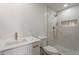 Bathroom featuring quartz countertops, sleek fixtures, and walk-in shower with decorative tile at 5731 W Morten Ave, Glendale, AZ 85301