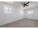 This bedroom is freshly painted and features new flooring and a ceiling fan at 5731 W Morten Ave, Glendale, AZ 85301