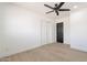 This bedroom features a ceiling fan and a closet at 5731 W Morten Ave, Glendale, AZ 85301