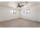 Bright bedroom with sleek floors, two sunny windows, and a ceiling fan to ensure your comfort at 5731 W Morten Ave, Glendale, AZ 85301