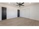 Bedroom showcasing sleek floors, ceiling fan, and closet with sliding doors for an efficient space at 5731 W Morten Ave, Glendale, AZ 85301