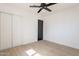 This bedroom features new wood floors, a ceiling fan, and a closet at 5731 W Morten Ave, Glendale, AZ 85301