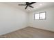 This bedroom is freshly painted and features new flooring and a ceiling fan at 5731 W Morten Ave, Glendale, AZ 85301