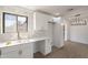 Bright kitchen featuring white cabinets, counters, and herringbone backsplash at 5731 W Morten Ave, Glendale, AZ 85301