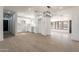 Bright white kitchen with modern light fixture, white cabinets, and light wood flooring at 5731 W Morten Ave, Glendale, AZ 85301