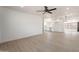 Spacious open-concept living room with views into kitchen, showcasing light wood floors at 5731 W Morten Ave, Glendale, AZ 85301