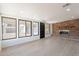 Bright living room with lots of windows and an accent brick wall at 5731 W Morten Ave, Glendale, AZ 85301