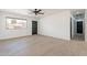 Open concept living room featuring wood-look floors, fresh paint, and contemporary ceiling fan at 5731 W Morten Ave, Glendale, AZ 85301