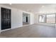 Bright, light-filled living room featuring sleek floors and large windows that offer views of the neighborhood at 5731 W Morten Ave, Glendale, AZ 85301