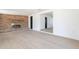 Bright living room with an accent brick wall and white walls at 5731 W Morten Ave, Glendale, AZ 85301