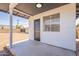 Charming covered patio with a dark door that provides easy access to the backyard at 5731 W Morten Ave, Glendale, AZ 85301