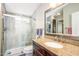 Modern bathroom featuring walk-in shower with glass door and vanity with granite countertop, and view to second bathroom at 6177 S Sawgrass Dr, Chandler, AZ 85249