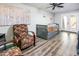 Bedroom with modern ceiling fan, twin daybed, sitting chairs, and double doors leading to outdoor area at 6177 S Sawgrass Dr, Chandler, AZ 85249